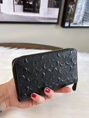 COACH BLACK EMBOSSED SIGNATURE LEATHER ZIP WALLET WITH GOLD HARDWARE - BLACK - Like New