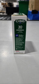 CURAD FABRIC ANTIBACTERIAL BANDAGE, OUCHLESS MEDICATED PAD, 30 BANDAGES - Brand New