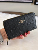 COACH BLACK EMBOSSED SIGNATURE LEATHER ZIP WALLET WITH GOLD HARDWARE - BLACK - Like New